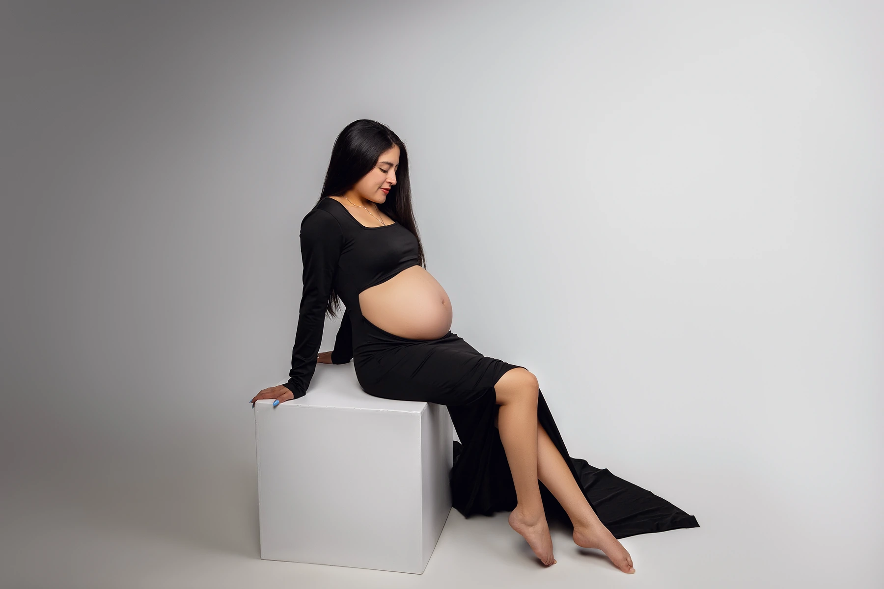 Pregnant woman in a black gown, studio maternity portraity, shot by Tender Beginning