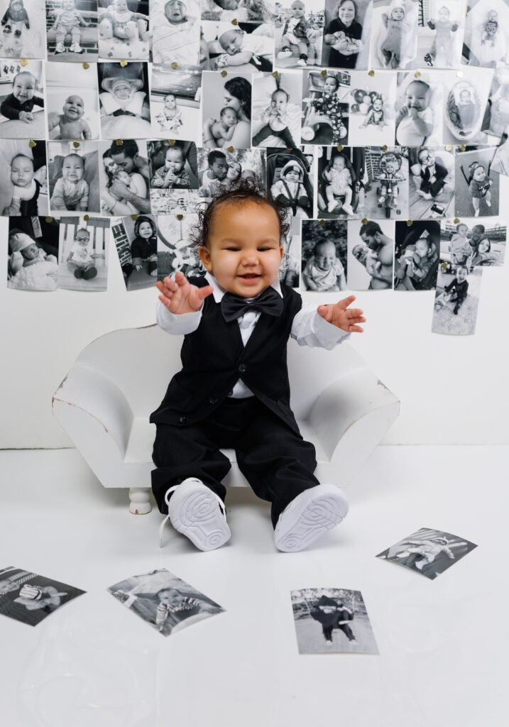 Toddler boy cake smash session with a black-and-white photo backdrop, shot by Tender Beginning