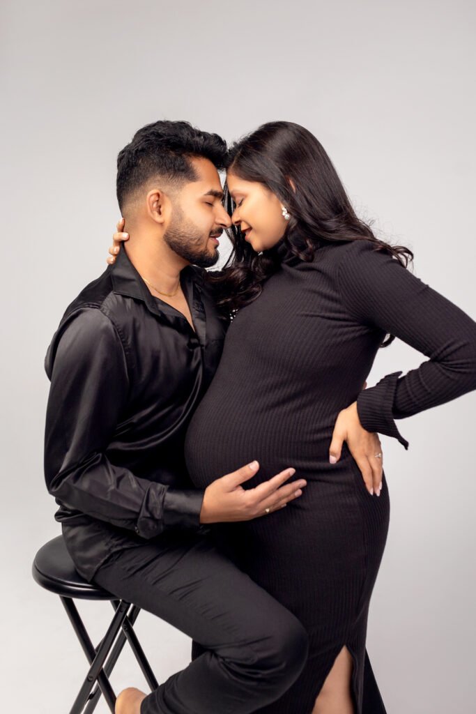 Couple maternity portrait, embracing in the studio, shot by Tender Beginning