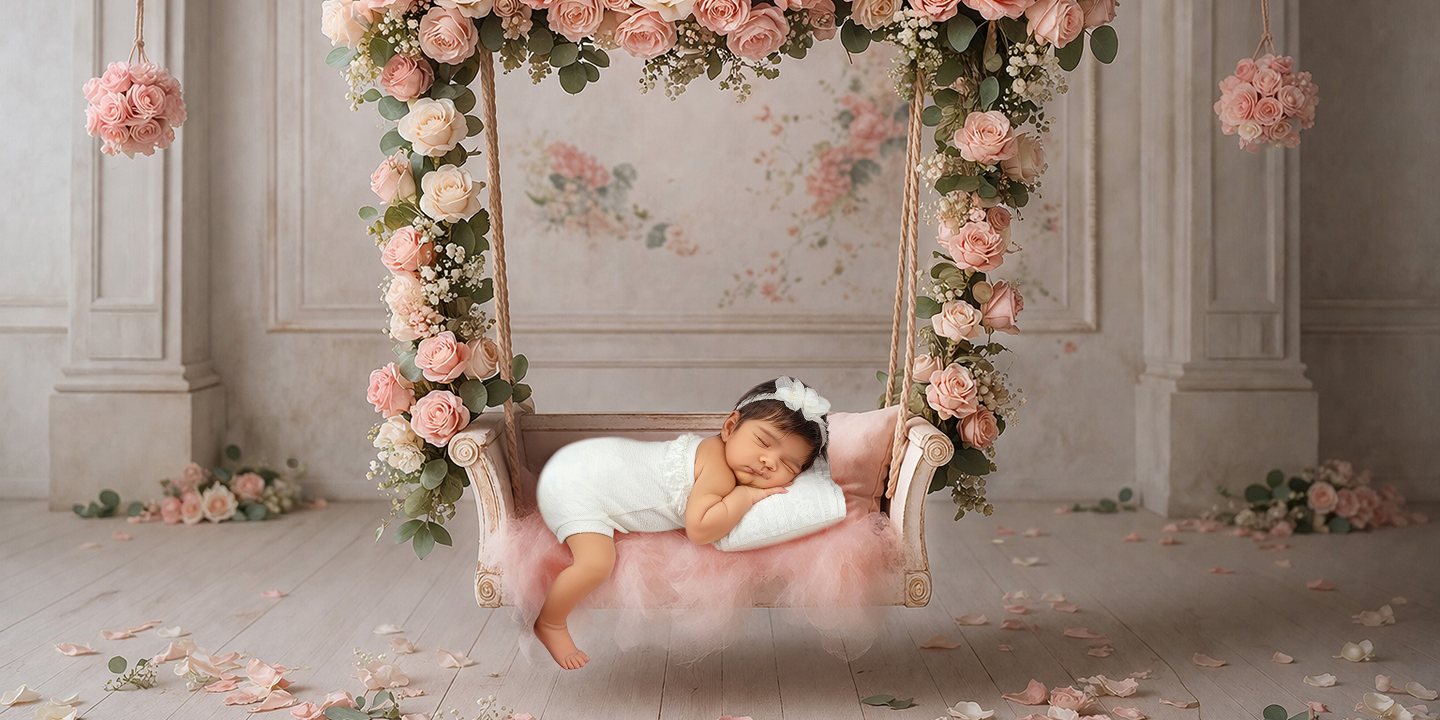 Sleeping newborn baby girl comfortably posed in a hanging floral wreath swing, highlighting the unique, high-quality props available at our Richboro studio.